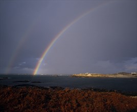 UNITED KINGDOM, Channel Islands, Guernsey, Double Rainbow over Lihou Island