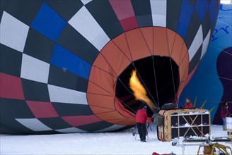 SWITZERLAND, Canton de Vaud, Chateau d'Oex, Flame being directed into inflated Hot Air Balloon to