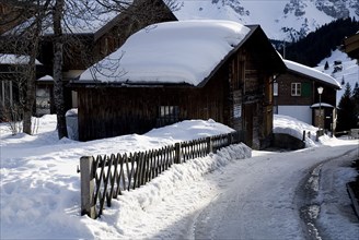SWITZERLAND, Bernese Oberland, Murren, Snow covered house in the centre of Murren town.