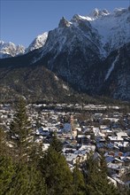 GERMANY, Bavaria, Mittenwald, View over Mittenwald town rooftops from surrounding hillside with