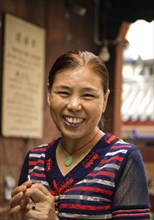 CHINA, Sichuan Province, Chongqing, "Portrait of a smiling woman, an Arhat Temple incense stick