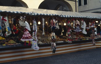 ITALY, Veneto, Padua, Puppets of New Year witch La Befana on street stall in Piazza del Erbes. La
