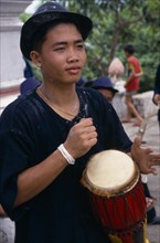 LAOS, Luang Phrabang, Portrait of drummer celebrating the lunar New Year.