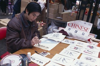 ENGLAND, London, Chinese New Year, Chinese painter working at stall during New Year celebrations in