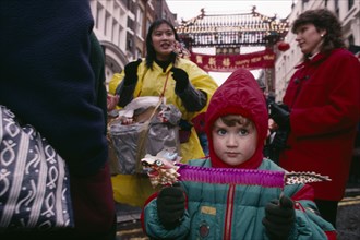ENGLAND, London, Chinese New Year, "Young non-Chinese child holding paper lion during Chinese New