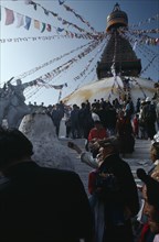 NEPAL, Kathmandu, Bodhanath, Crowd of Tibetans offering incense on the steps of the main stupa