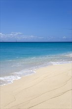 WEST INDIES, St Vincent And The Grenadines, Canouan, South Glossy Beach in Glossy Bay with waves
