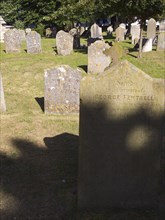 ENGLAND, West Sussex, Shoreham-by-Sea, Weather worn headstones in the cemetery of the Church os St
