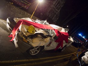 TRANSPORT, Road, Cars, Wrecked car wrapped in red bow as part of a police anti Drink Drive campaign