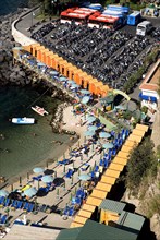 20093623 ITALY Campania Sorrento Terrace viewpoint of small beach with beach huts and large car park in background