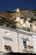 20093627 ITALY Campania Positano Streetscape in town centre with Church of Santa Maria Assunta and its majolica dome
