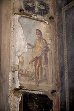20093696 ITALY Campania Pompeii A fresco on a wall in the House of the Vettii  Priapus admiring himself