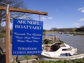 ENGLAND, West Sussex, Arundel, Sign for boatyard on the riverbank.