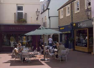 ENGLAND, East Sussex, Brighton, People sat at tables outside cafe in Dukes Lane.