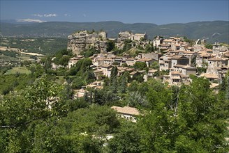 FRANCE, Provence Cote d’Azur, Vaucluse, "Saignon.  Provencal hilltop village with Mont Ventoux seen