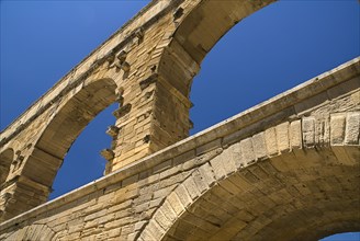 FRANCE, Provence Cote d’Azur, Gard, Pont du Gard.  Close up detail of section of tiered arches of