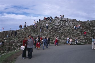 NORTHERN IRELAND, County Antrim, Giants Causeway, Visitors walking over the interlocking basalt