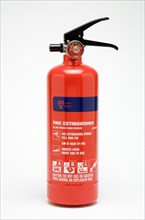 INDUSTRY, Health and Safety, Fire, A red ABC category powder fire extinguisher on a white