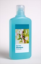 HEALTH, Hygiene, Washing Hair, A blue plastic bottle of Tea Tree shampoo on a white background