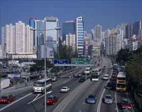 CHINA, Hong Kong, Causeway Bay, Multi-lane city road busy with traffic beside Causeway Bay boats