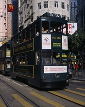 CHINA, Hong Kong, Hong kong Island tram on city street with high rise buildings and advertising