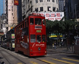 CHINA, Hong Kong, Hong kong Island trams on city street with high rise buildings and advertising