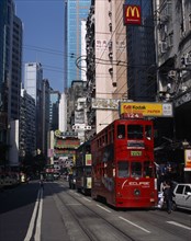 CHINA, Hong Kong, Hong kong Island trams on city street with high rise buildings and advertising