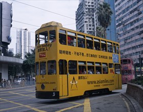 CHINA, Hong Kong, "Hong kong Island tram with passengers on top deck looking out of windows,