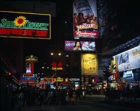 CHINA, Hong Kong, Kowloon, Illuminated advertising hoarding and neon signs on Nathan Road at night
