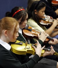 CHILDREN, Education, Music, "School orchestra, girls playing violins pizzicato style."