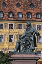 POLAND, Wroclaw, Detail of building facade with tromp l oeil painted mural.  Seated statue of