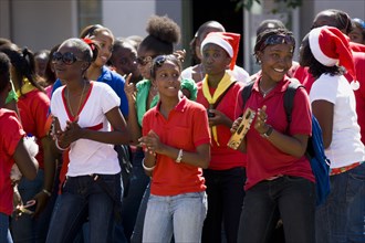 WEST INDIES, Grenada, St Georges, Girl Guides at Christmas singing carols in the street as part of