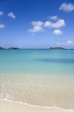 WEST INDIES, Grenada, Carriacou, The calm clear blue water breaking on Paradise Beach in L'Esterre