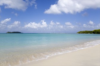 WEST INDIES, Grenada, Carriacou, The calm clear blue water breaking on Paradise Beach in L'Esterre