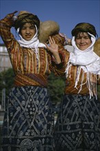 TURKEY, East, People, Three quarter portrait of two girls carrying gourd vessels.