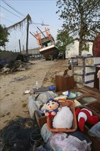 THAILAND, Phang Nga District, Nam Khem, "Tsunami. Childrens toys ly piled up and Boats have been