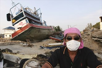 THAILAND, Phang Nga District, Nam Khem, "Tsunami. A volenteer takes a break from the clean up of
