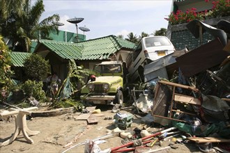 THAILAND, Phang Nga District, Phuket, "Tsunami carnage the day after. Two cars are left in the