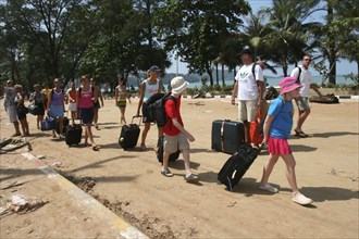 THAILAND, Phang Nga District, Phuket, "Tsunami carnage the day after. Tourists leaving with what