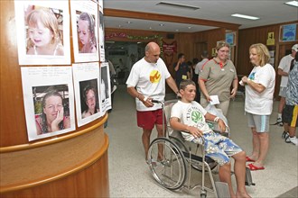 THAILAND, Phuket, "Tsunami. Foreign tourists at the entrance of Vachira hospital, with pictures of