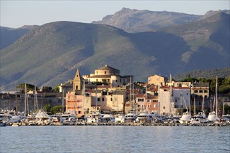 FRANCE, Corsica, St Florent, Old Town & harbour with mountain backdrop