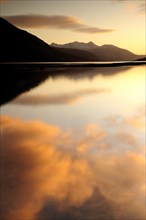 Scotland, Argyll, Loch Etive, Sunset coloured clouds reflected in Loch Etive