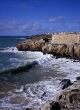 PORTUGAL, Estremadura, Ribatejo, Peniche. Atlantic Ocean town. Sea and cliffs topped by part of