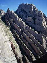 SPAIN, Catalonia, Lleida, Near vertical strata of crumbling limestone rock along Rio Noguera