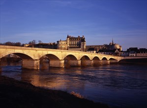 FRANCE, Indre et Loire, Amboise, Chateau at Amboise and bridge seen from the flowing River Loire.