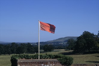 ENGLAND, East Sussex, Glyndebourne, Red flag in the grounds of the country house and opera house