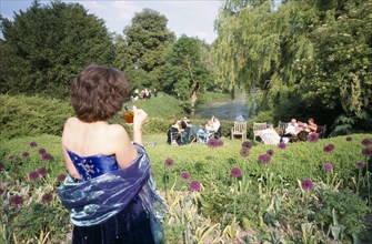 ENGLAND, East Sussex, Glyndebourne, Opera attendees enjoying picnics in the gardens during interval