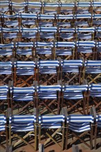 ENGLAND, East Sussex, Eastbourne, Details of blue and white deck chairs at the band stand.