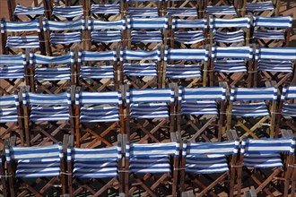 ENGLAND, East Sussex, Eastbourne, Details of blue and white deck chairs at the band stand.