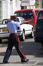 WEST INDIES, Grenada, St Georges, Corporal in the Royal Granada Police Force directing traffic at